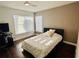 Clean bedroom with large bright windows with wooden floors and a full sized bed at 4907 Kilty E Ct, Bradenton, FL 34203