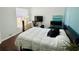Cozy bedroom with a large window, desk, TV and comfortable bed, perfect for relaxation or work at 4907 Kilty E Ct, Bradenton, FL 34203