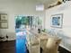 Elegant dining room with a chandelier, a rustic wooden table and direct access to the outdoor pool area at 4907 Kilty E Ct, Bradenton, FL 34203