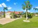 Beautiful single-story home featuring lush landscaping, a brick driveway, and a two-car garage under a sunny blue sky at 4907 Kilty E Ct, Bradenton, FL 34203