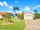 Charming single-story home with a well-maintained lawn, lush landscaping and a brick driveway under a clear sky at 4907 Kilty E Ct, Bradenton, FL 34203