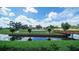 Picturesque golf course with a pond and walking bridge, offering a tranquil and scenic golfing experience at 4907 Kilty E Ct, Bradenton, FL 34203