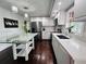 Bright kitchen with white cabinets, stainless steel appliances, and a glass-top kitchen island at 4907 Kilty E Ct, Bradenton, FL 34203