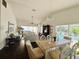 Bright living room features vaulted ceilings, tile floors, and an open floor plan that connects to the dining area at 4907 Kilty E Ct, Bradenton, FL 34203
