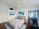 This main bedroom features modern decor, a ceiling fan, ocean art and comfortable furniture at 4907 Kilty E Ct, Bradenton, FL 34203