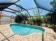 A pristine pool is enclosed in a screened enclosure, surrounded by lush greenery, offering a private outdoor retreat at 4907 Kilty E Ct, Bradenton, FL 34203