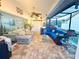A sunroom showcases brick floors, comfortable seating, nautical décor and expansive views at 4907 Kilty E Ct, Bradenton, FL 34203