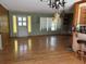 Spacious living room with hardwood floors, natural light, and an elegant light fixture at 4959 Habana Dr, Sarasota, FL 34235