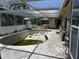 A view of the backyard featuring a dated swimming pool surrounded by a patio at 4959 Habana Dr, Sarasota, FL 34235