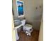 Compact powder room featuring a toilet and pedestal sink at 4959 Habana Dr, Sarasota, FL 34235