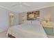 Bedroom with a decorative mirror on the wall and an open door to the bathroom at 519 Albee Farm Rd # 212, Venice, FL 34285