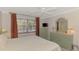 Bedroom featuring a large window, ceiling fan, and light green dresser at 519 Albee Farm Rd # 212, Venice, FL 34285