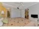 Bedroom with closet and bathroom access, featuring a large window and ceiling fan at 519 Albee Farm Rd # 212, Venice, FL 34285