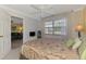 Bright bedroom featuring a ceiling fan and an adjacent living area through a doorway at 519 Albee Farm Rd # 212, Venice, FL 34285