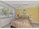 Cozy bedroom with a ceiling fan, large windows, and neutral tones for a relaxing atmosphere at 519 Albee Farm Rd # 212, Venice, FL 34285