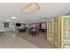 Spacious clubhouse with tile entryway, carpet, and multiple seating areas for community gatherings at 519 Albee Farm Rd # 212, Venice, FL 34285