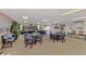 Bright clubhouse offers multiple seating areas, bookshelves, kitchenette, and access to outdoor space at 519 Albee Farm Rd # 212, Venice, FL 34285