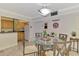 Dining area featuring a glass table with seating for four, open to the kitchen at 519 Albee Farm Rd # 212, Venice, FL 34285