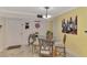 Bright dining area featuring a glass table with seating for four, and stylish decor at 519 Albee Farm Rd # 212, Venice, FL 34285