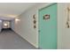 Carpeted hallway with natural lighting, leading to individual condo units at 519 Albee Farm Rd # 212, Venice, FL 34285