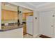 Compact kitchen with light wood cabinets, granite countertops, and breakfast bar at 519 Albee Farm Rd # 212, Venice, FL 34285