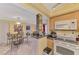 The kitchen with granite countertops offers a view to the open concept living and dining areas at 519 Albee Farm Rd # 212, Venice, FL 34285
