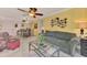 Open-concept living room and dining area with tile flooring, seating, and a glass coffee table at 519 Albee Farm Rd # 212, Venice, FL 34285