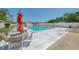 Community pool surrounded by lounge chairs and tables with umbrellas at 519 Albee Farm Rd # 212, Venice, FL 34285