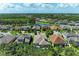 Community aerial view showcasing homes, landscaping, and nearby lake at 5307 65Th E Ter, Ellenton, FL 34222