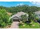 Stunning aerial view of a single-Gathering home with a brick driveway, mature trees, and lush landscaping at 5307 65Th E Ter, Ellenton, FL 34222