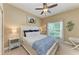 Cozy bedroom features carpet flooring, a ceiling fan, and a well-lit window with natural light at 5307 65Th E Ter, Ellenton, FL 34222