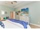 Bedroom features a bright window, wood flooring, and a rustic dresser with decor at 5307 65Th E Ter, Ellenton, FL 34222