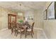 Cozy dining area with decorative light fixture, wood table set, and china cabinet at 5307 65Th E Ter, Ellenton, FL 34222