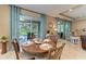 Cozy dining room with round wooden table and comfortable seating overlooking the screened porch at 5307 65Th E Ter, Ellenton, FL 34222