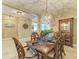 Elegant dining room with decorative lighting, detailed table setting, and carved wood furniture at 5307 65Th E Ter, Ellenton, FL 34222