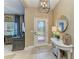 Bright foyer with tile flooring, decorative lighting, a stylish console table, and an elegant front door at 5307 65Th E Ter, Ellenton, FL 34222