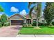 Charming single-Gathering home features a well-maintained lawn, mature palm tree, and a two-car garage at 5307 65Th E Ter, Ellenton, FL 34222