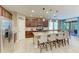 Modern kitchen with stainless steel appliances, an island with seating, and a sliding glass door to outside at 5307 65Th E Ter, Ellenton, FL 34222