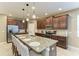 Spacious kitchen with stainless steel appliances, a large island, granite countertops, and bar stool seating at 5307 65Th E Ter, Ellenton, FL 34222