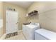 Bright laundry room featuring washer, dryer, storage, and access to the garage at 5307 65Th E Ter, Ellenton, FL 34222