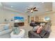 Inviting living room with a large TV, comfortable seating, ceiling fan, and stylish decor at 5307 65Th E Ter, Ellenton, FL 34222
