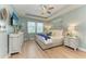 Serene main bedroom featuring soft blue walls, tray ceiling, and elegant furnishings creating a relaxing retreat at 5307 65Th E Ter, Ellenton, FL 34222