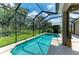 Sparkling pool surrounded by a screened enclosure and lush landscaping providing a private oasis at 5307 65Th E Ter, Ellenton, FL 34222