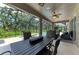 Spacious screened porch with outdoor seating, ceiling fan, and fire feature overlooking the pool area at 5307 65Th E Ter, Ellenton, FL 34222