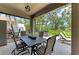 Outdoor screened porch with table, chairs, and grill, perfect for outdoor dining at 5307 65Th E Ter, Ellenton, FL 34222