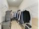 Walk-in closet features wire shelving and ample storage space with hardwood floors at 5307 65Th E Ter, Ellenton, FL 34222