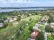 Overhead view showcasing a home's location near a golf course, lake, and verdant neighborhood at 5349 Everwood Run, Sarasota, FL 34235