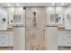 This modern bathroom is well-appointed with granite counters and a tiled glass shower at 5349 Everwood Run, Sarasota, FL 34235
