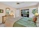 Relaxing primary bedroom features comfortable bedding, a walkout to a patio, and outdoor views at 5349 Everwood Run, Sarasota, FL 34235