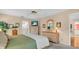 Relaxing primary bedroom is well-lit with neutral decor, tv, and ensuite bathroom at 5349 Everwood Run, Sarasota, FL 34235
